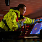 man on boat using monitor
