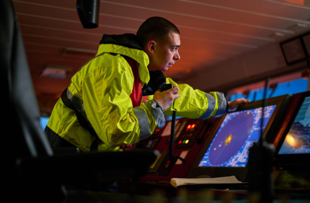 man on boat using monitor
